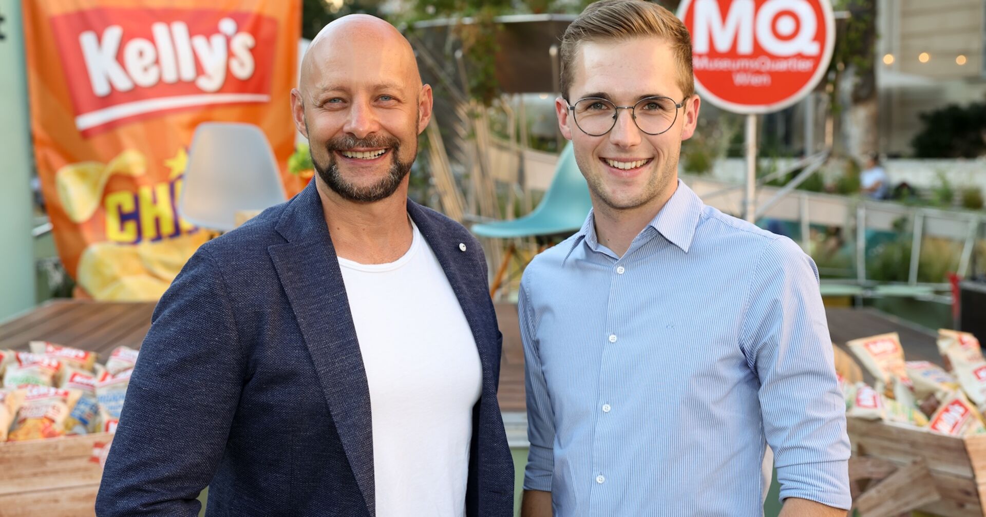 Zwei Männer vor einem Chips-Sackerl in XXL