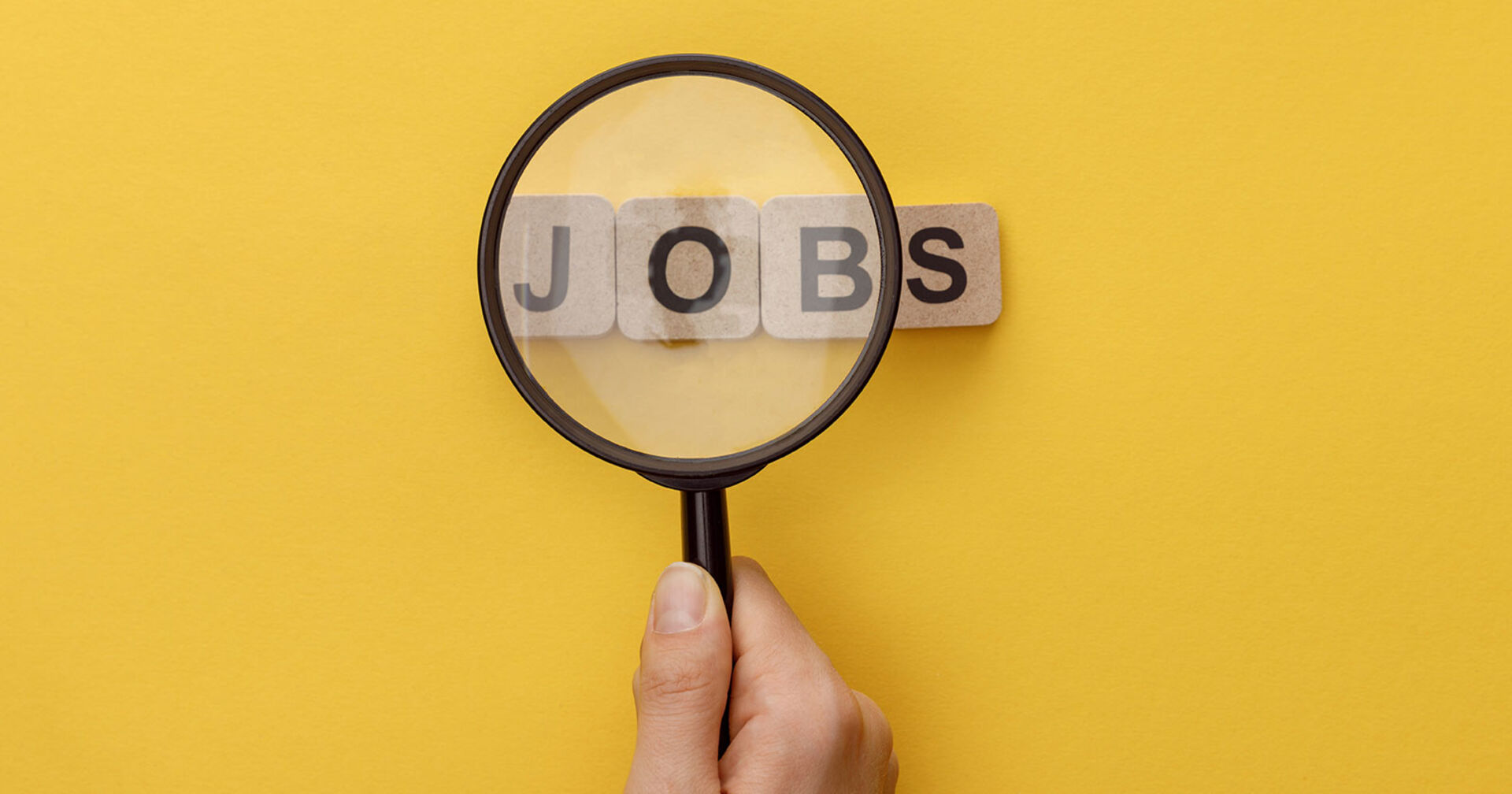 Das Wort &quot;Jobs&quot; durch eine Lupe gelesen | Credit: Adobe Stock/Lightfield Studios