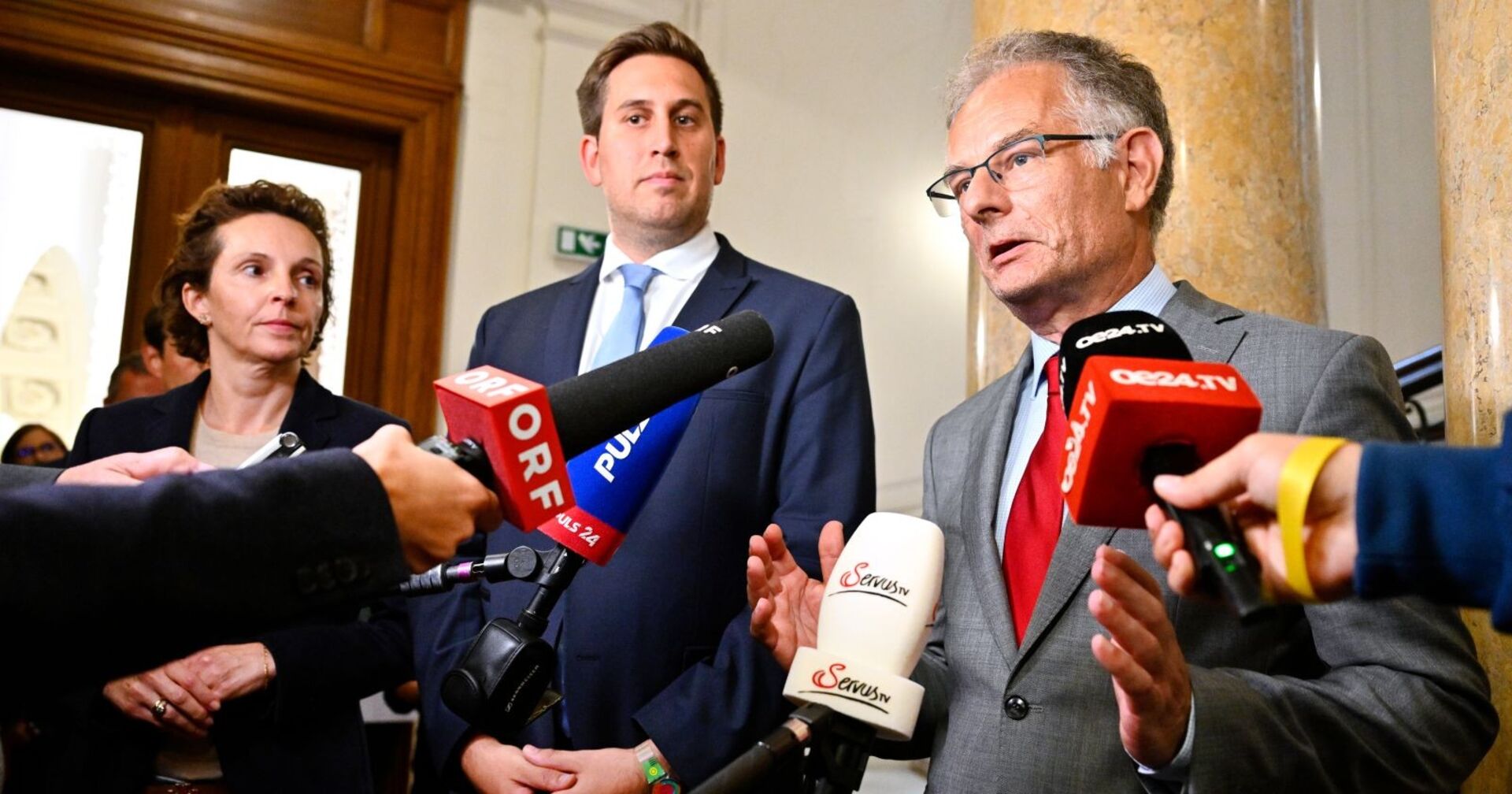 Alexander Pröll und Markus Marterbauer geben gemeinsam ein Statement zu den laufenden Nachverhandlungen der Beamtengehälter ab, umgeben von Mikrofonen mehrerer TV-Sender.