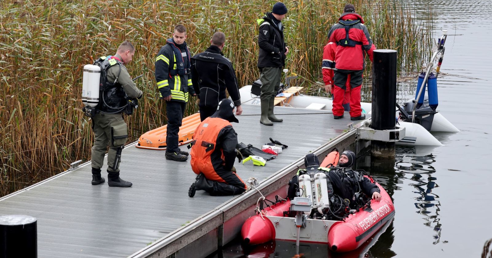 Taucher der Feuerwehr Rostock mit Boot und Ausrüstung am Schilfgürtel des Inselsees bei Güstrow während der Suche nach dem vermissten Fabian.