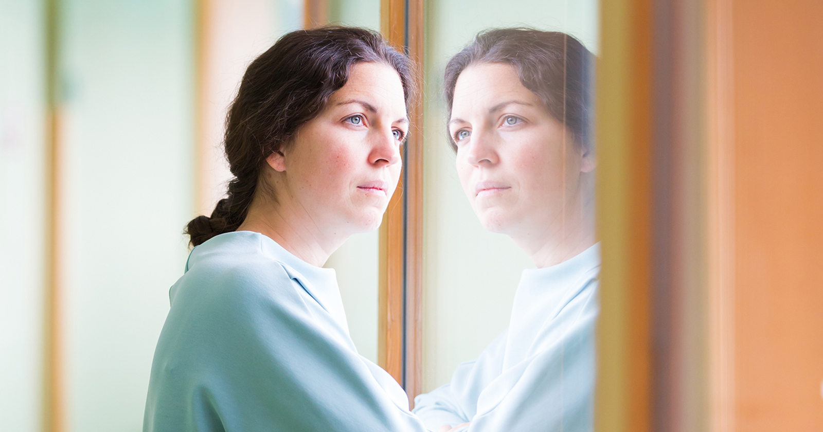 Frau blickt aus einem Fenster | Credit: Jugend am Werk Steiermark / Koco