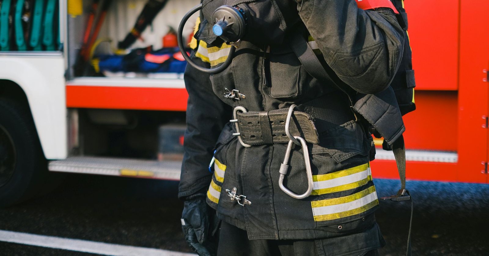 Feuerwehrmann in Uniform vor Wagen