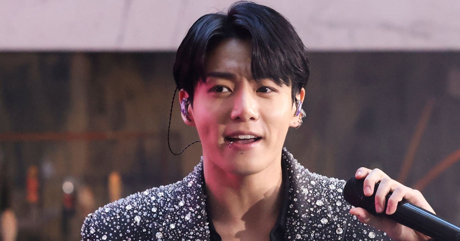 Jungkook mit Mikrophon in der Hand