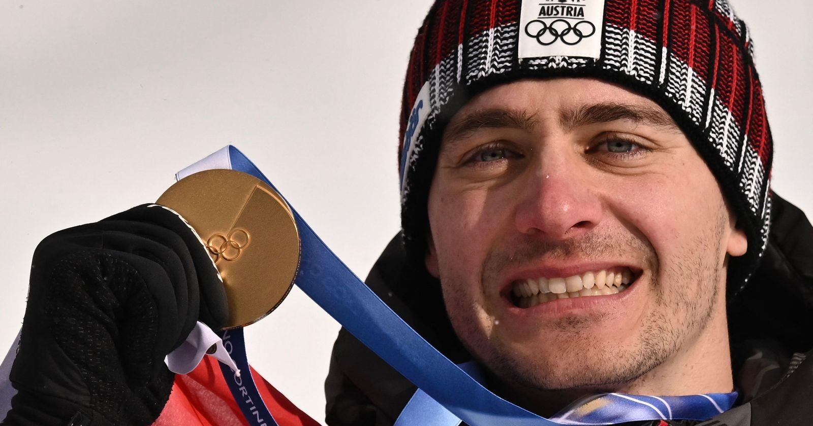 Alessandro Hämmerle hält seine Goldmedaille bei den Olympischen Winterspielen 2026 in Livigno und lächelt in die Kamera. Privat ist er seit Jahre mit Freundin bzw. jetzt Ehefrau Julia liiert