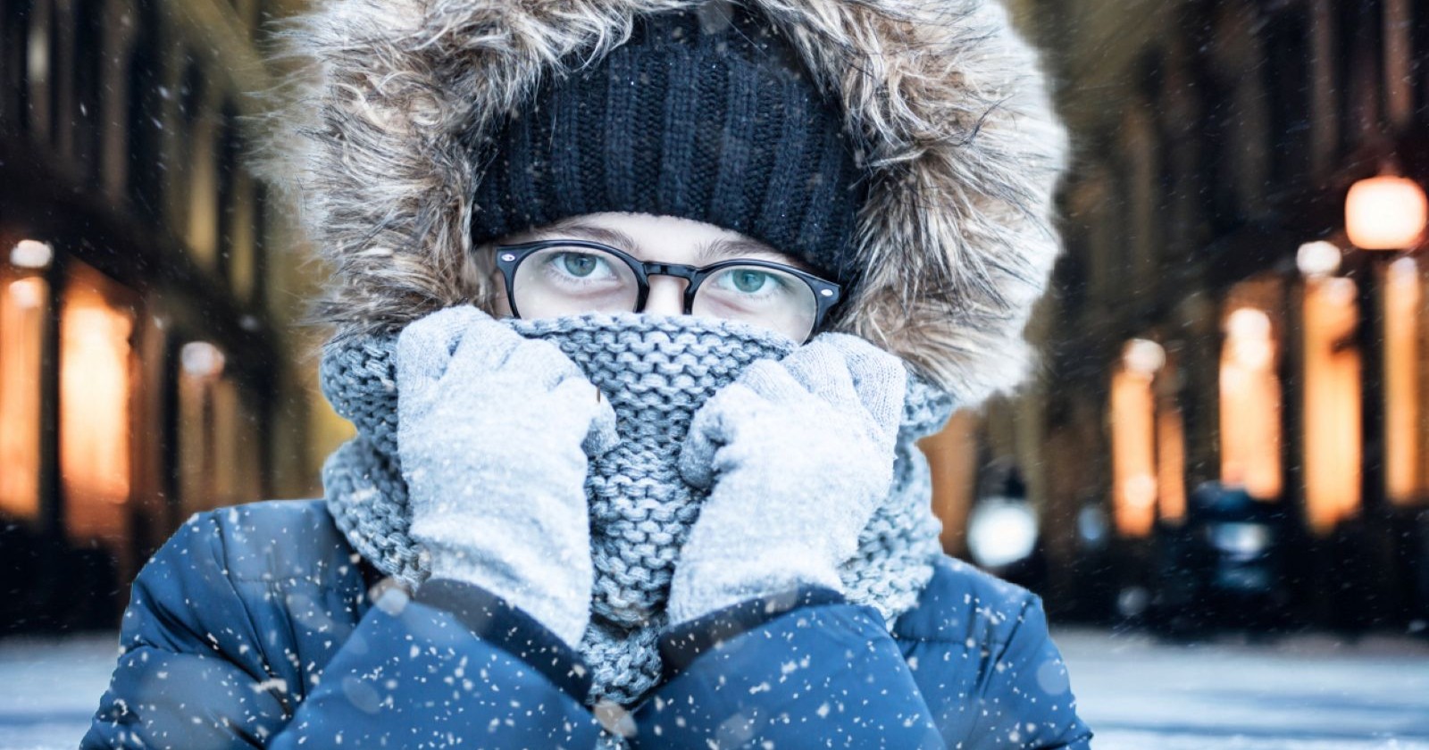 Frau, die in einer verschneiten, kalten Wiener Innenstadt steht