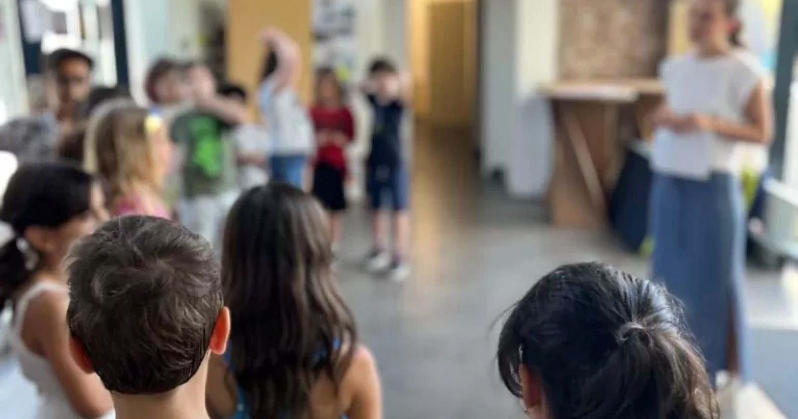 Gruppe von Volksschulkinder und Lehrerin, Gesichter unkenntlich