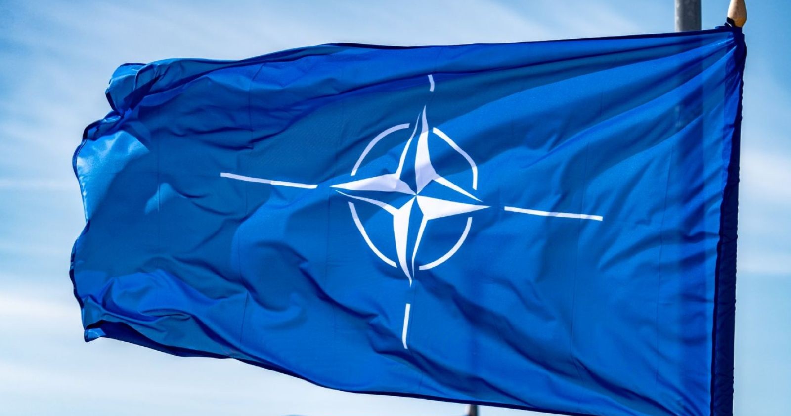 Nato-Flagge weht vor blauem Himmel – Nato erhöht Alarmbereitschaft im Iran-Krieg nach Angriffen bis zur Türkei.