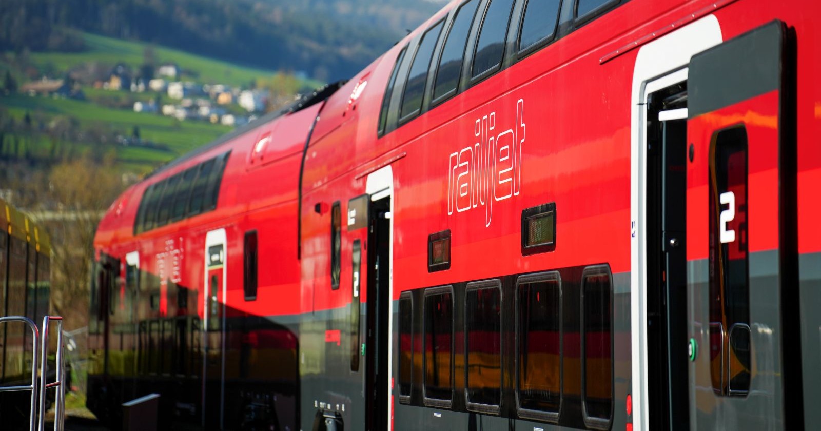 Roter ÖBB Railjet Zug auf Strecke in Österreich als Symbol für Vorteilscard Senior Frei und kostenlose Zugfahrten für Senior:innen