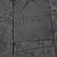 African wind engraved in the pavement of the forum