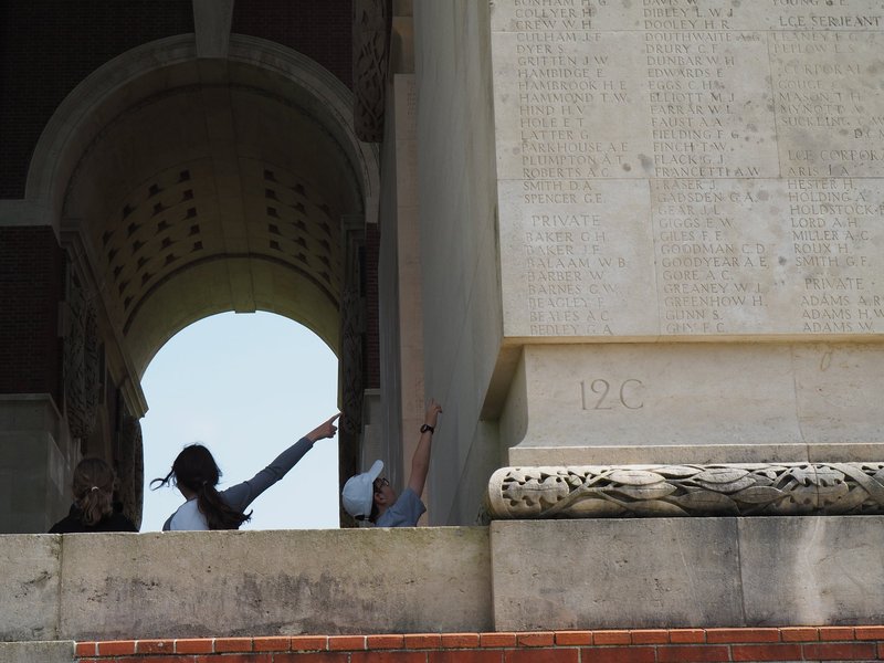 English child pointing to the name of a soldier killed in combat