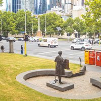 View of the bronze sculpture of Zelda D'Aprano and Eight Hour Day Memorial from inside the Victorian Trades Hall