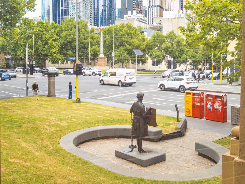 View of the bronze sculpture of Zelda D'Aprano and Eight Hour Day Memorial from inside the Victorian Trades Hall